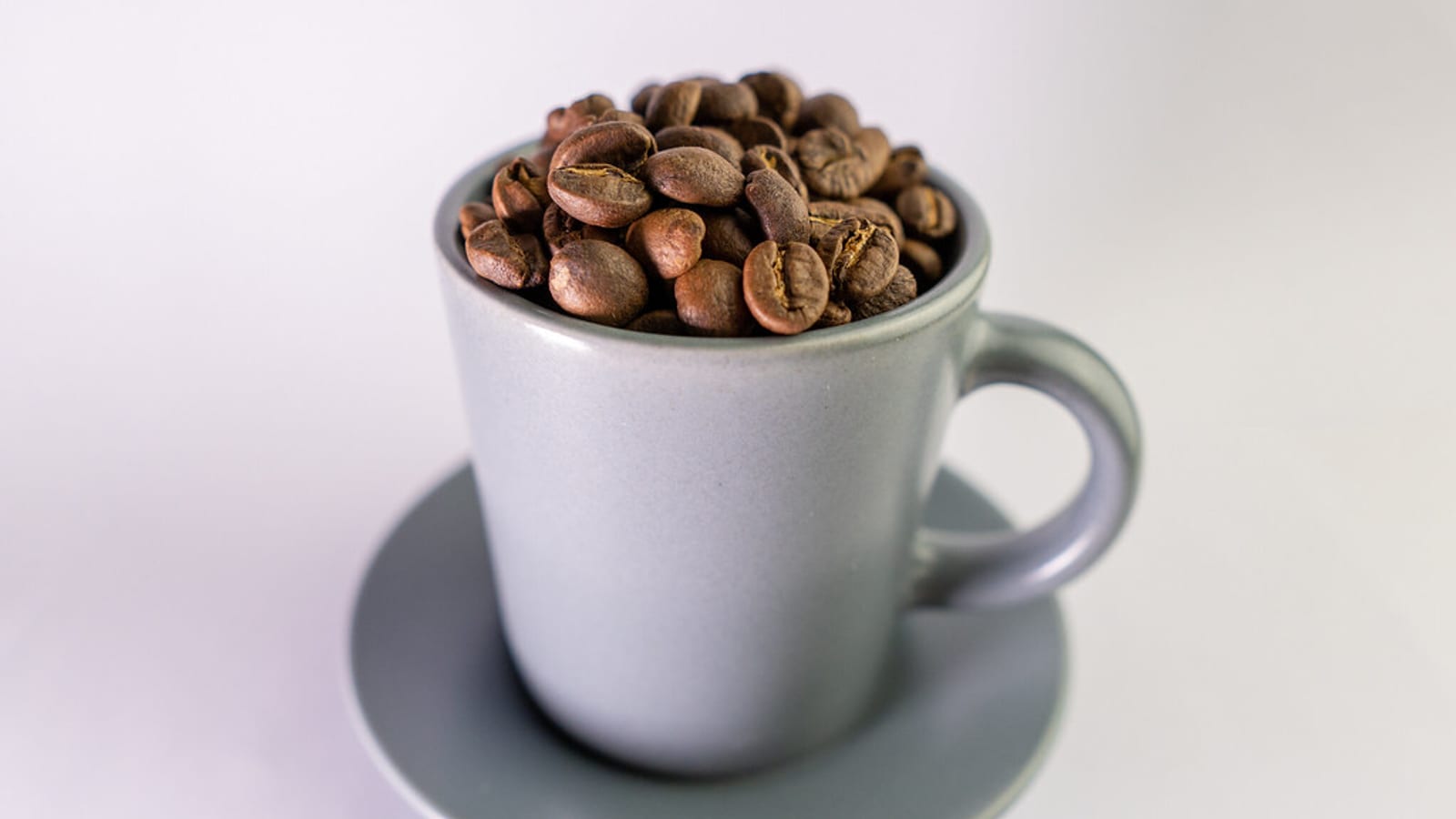 Fresh coffee beans and a cup of coffee